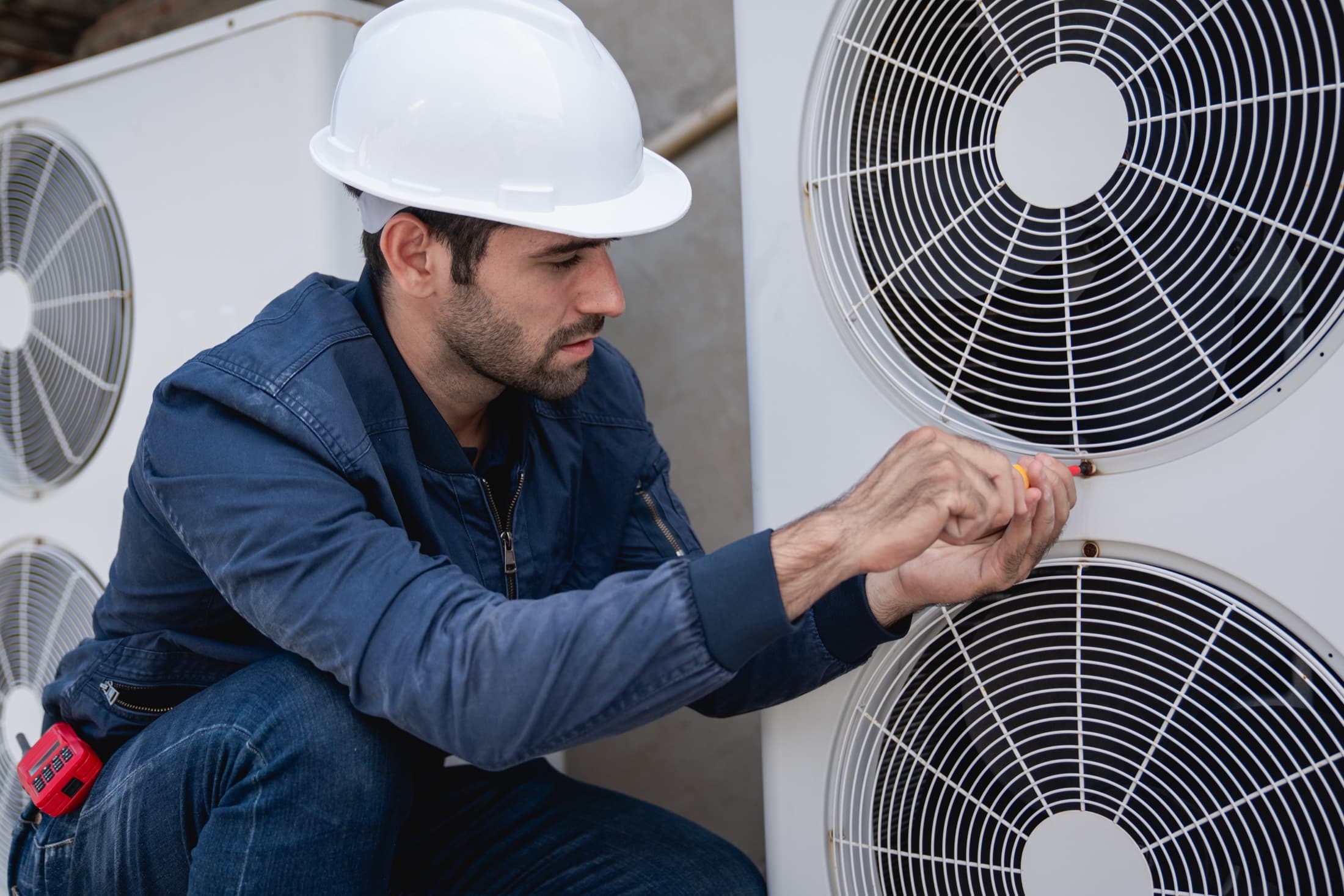 HVAC technician servicing an air-conditioning unit