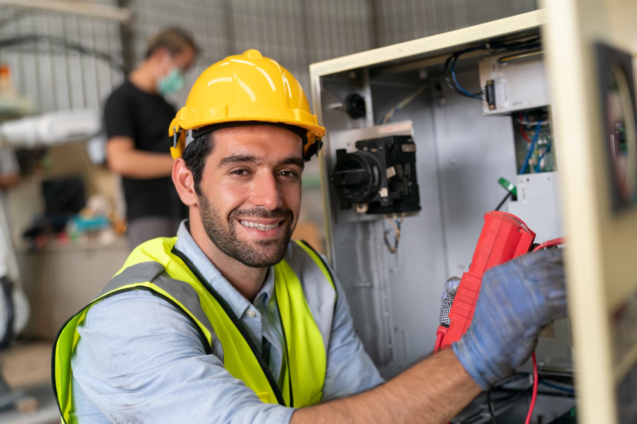 Electrician working on a building electrical panel